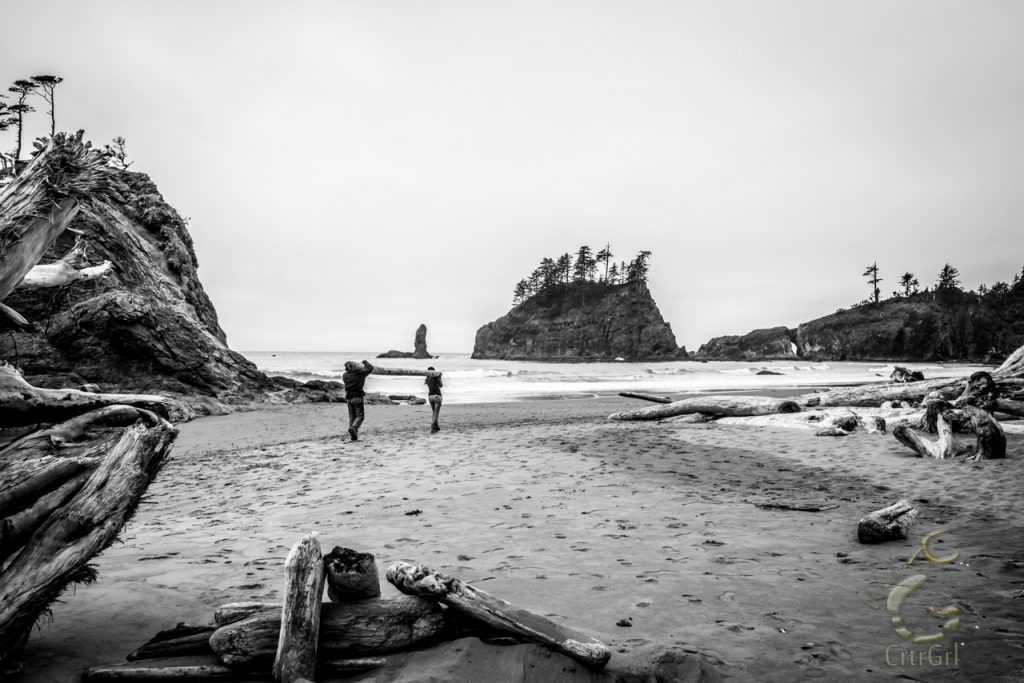 A humbling moment, where CrtrGrl helps a homeless man carry drift logs to build a shelter from the cold on 2nd Beach, WA. Photo by Scott McGee at Under Pressure Photography