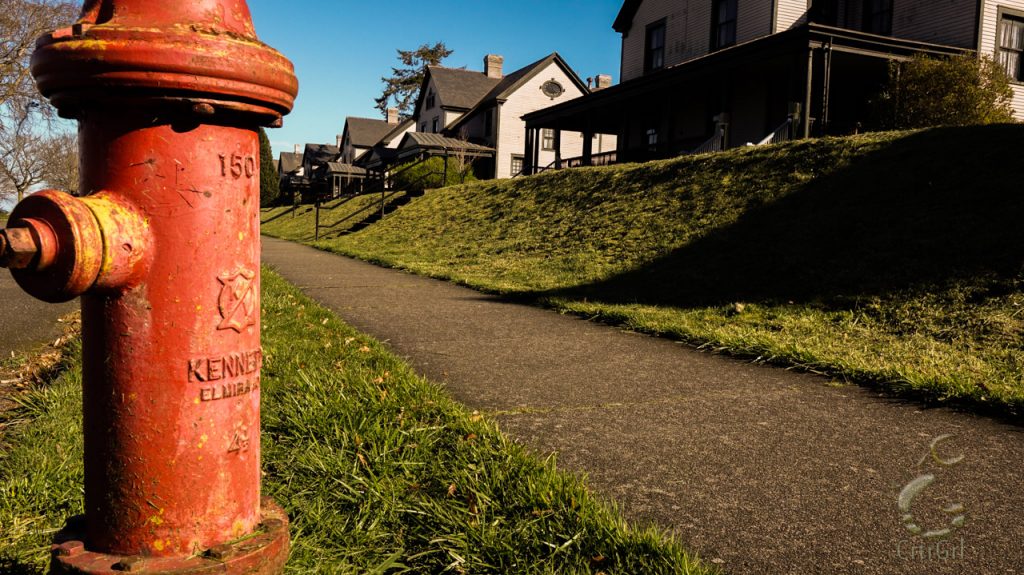 Red hydrant faces the Victorian style homes of Fort Worden State Park in Port Townsend.